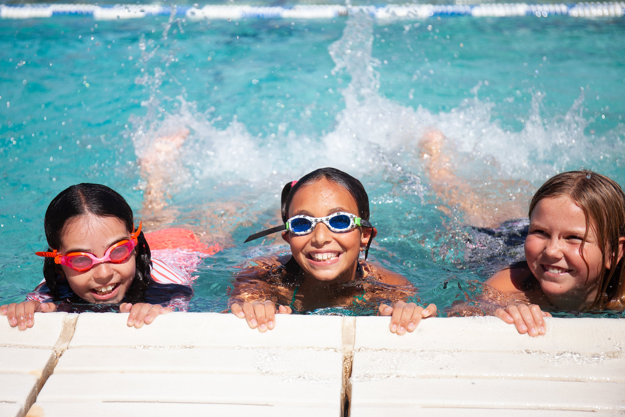 three kids enjoying pool time at jcc camp