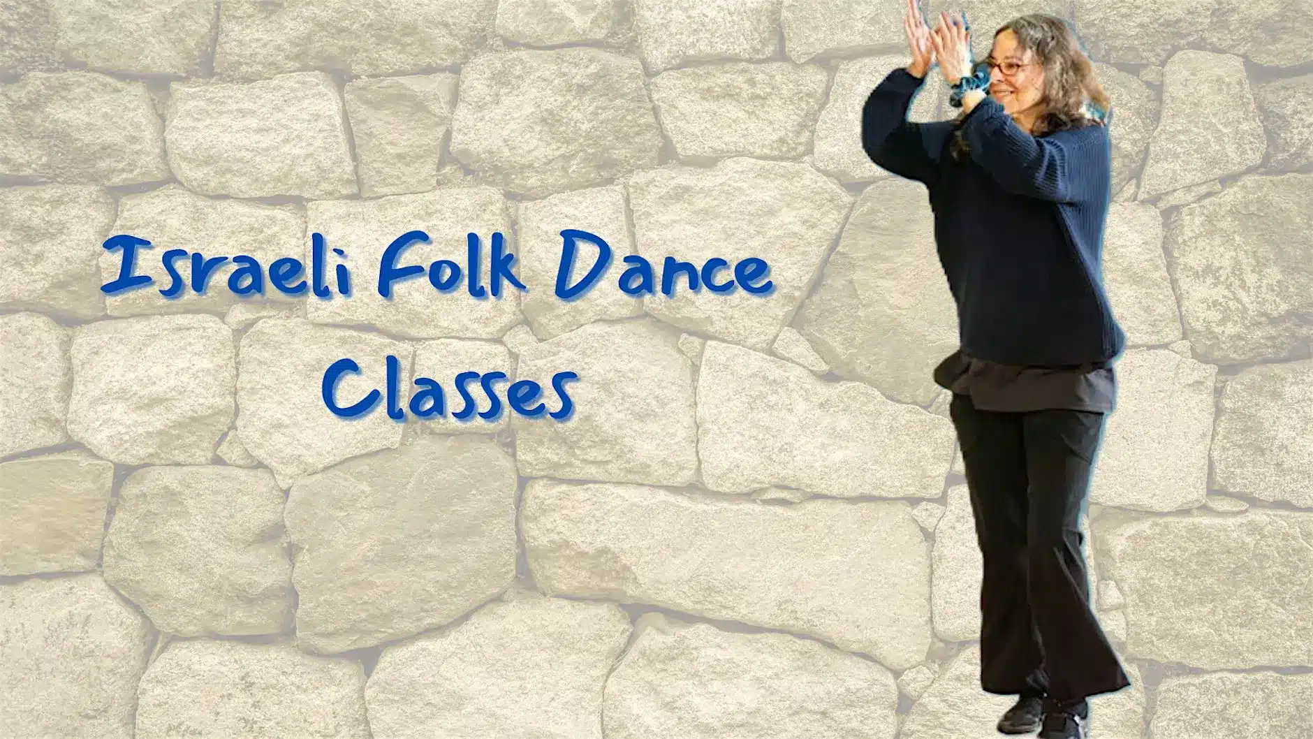A woman in dark clothing dances with her arms raised in front of a stone wall background. Blue text on the left reads "Israeli Folk Dance Classes.