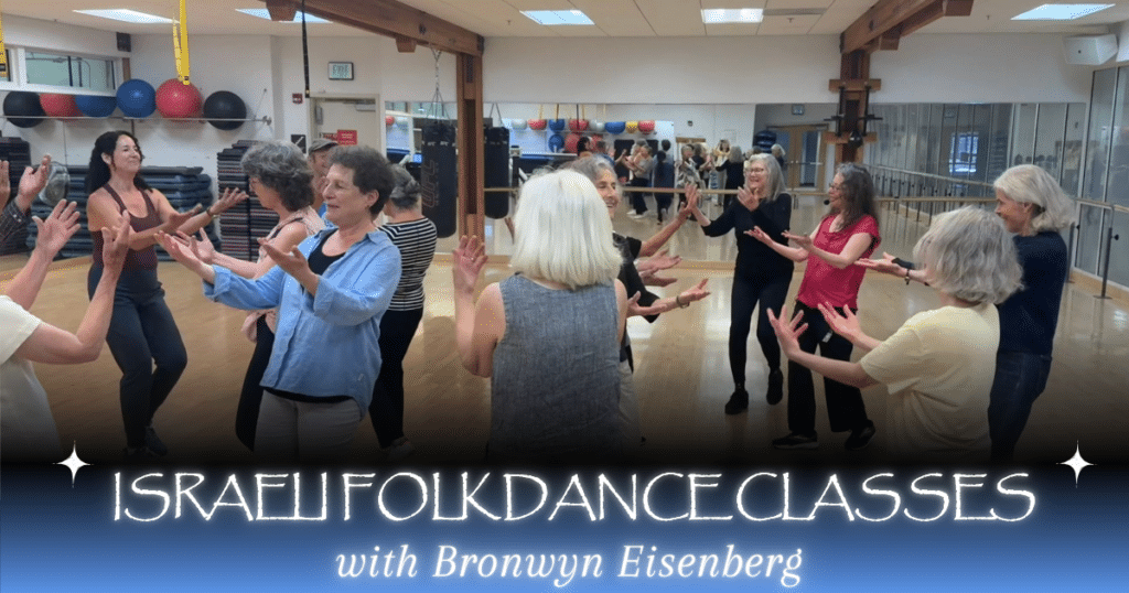 A group of women dance in a circle in a gym studio, smiling with raised hands. Text at the bottom reads, "Israeli Folkdance Classes with Bronwyn Eisenberg.