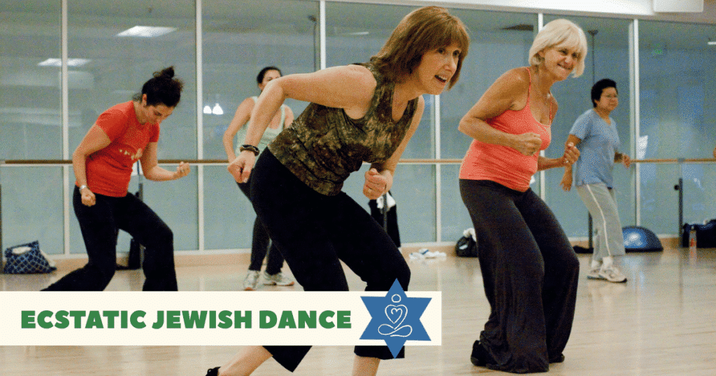 A group of women in workout clothes energetically dancing in a studio with large mirrors, with a banner reading "Ecstatic Jewish Dance" and a blue Star of David icon at the bottom.