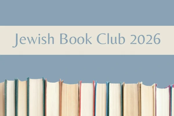A row of upright books with visible spines and pages, set against a blue background. Above the books, large text reads “Jewish Book Club 2026” on a beige banner.